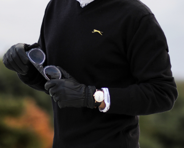 Man-in-Slazenger-Sweater-Holding-Golf-Gloves-and-Sunglasses